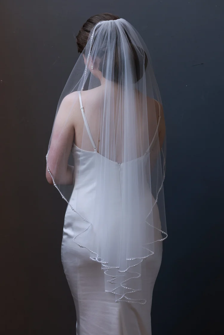 Pearl trimmed wavy cut fingertip length Maho Bay bridal veil by